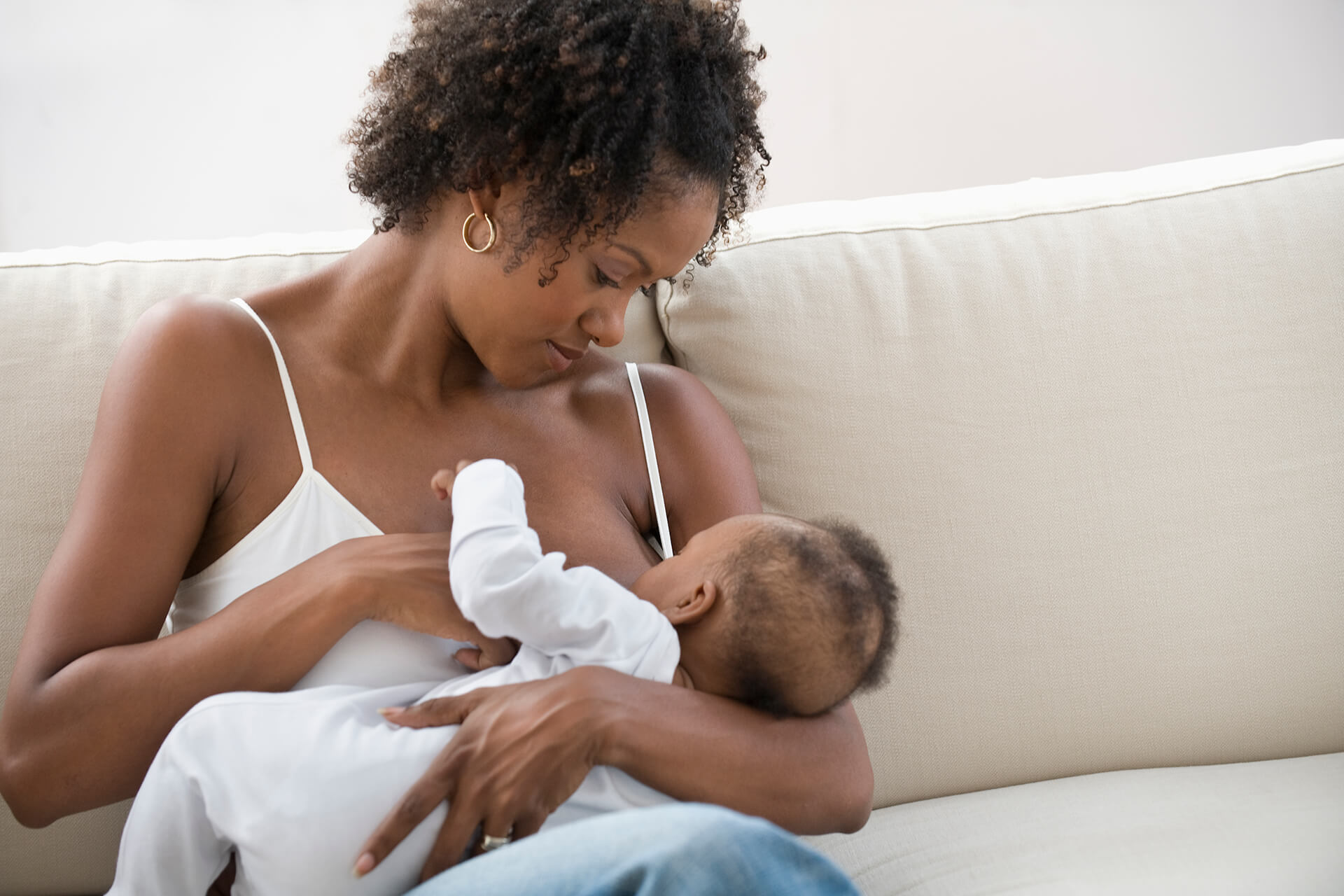 Black woman breastfeeding her newborn child